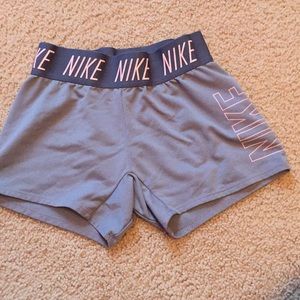 Gray and pink girls Nike size shorts.